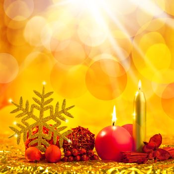 christmas golden snowflake with red candles on bokeh lights background