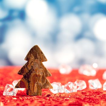 Christmas bark tree shape on ice cubes with blue lights bokeh background