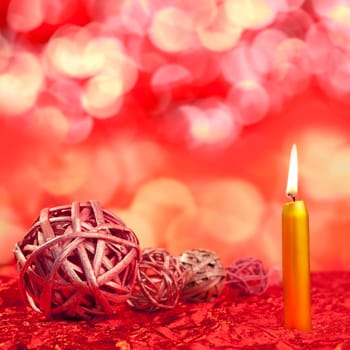 christmas candles with dried baubles on red lights background