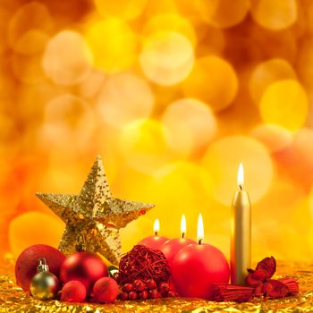 christmas golden star with red candles on bokeh lights background