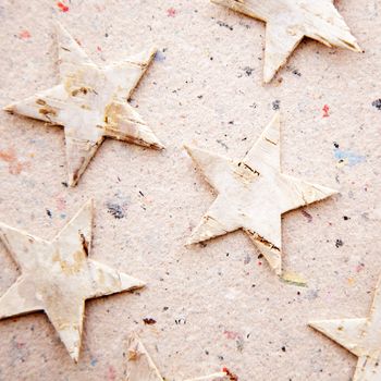 christmas stars on recycled paper background as an ecology metaphor