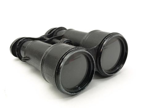 Antique black military issue field binoculars isolated on a white background.