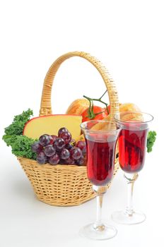 Red wine and a basket filled with bread and cheese.
