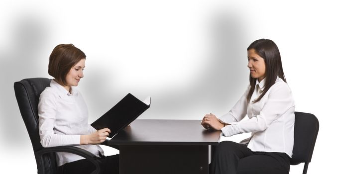 Two businesswomen at an interview in an office.