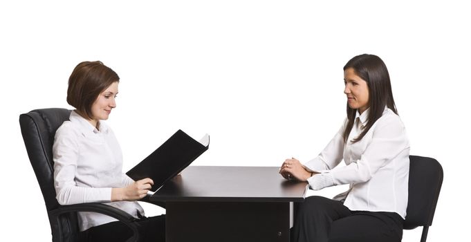 Two businesswomen at an interview in an office isolated against a white background.