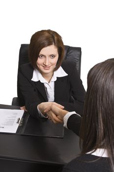 Businesswomen shaking hands in the office.