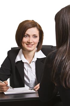 Two businesswomen at an interview in an office.The documents on the desk are mine.