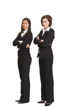 Two confident businesswomen standing up against a white background.