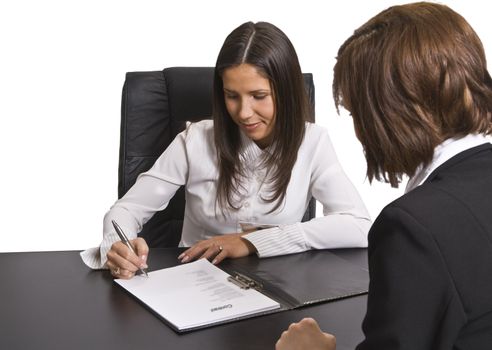 Two businesswomen signing a contract in the office. All the documents are mine.