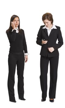Two businesswomen using mobile phones isolated against a white background.