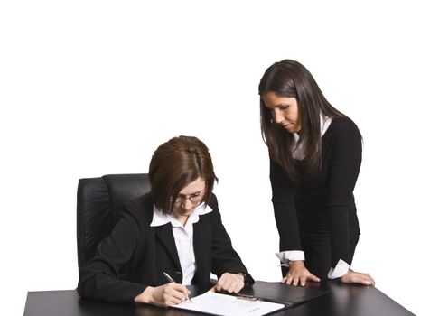 Two businesswomen signing a contract in the office. All the documents are mine.