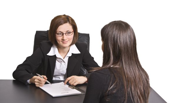 Two businesswomen at an interview in an office.The documents on the desk are mine.