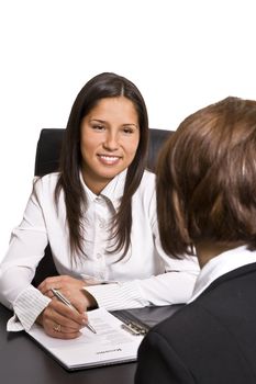 Two businesswomen at an interview in an office.The documents on the desk are mine.