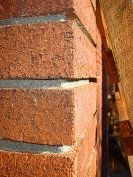 Corner of a brick building over blue sky.