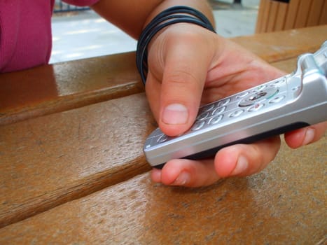 Person holding silver cell phone.