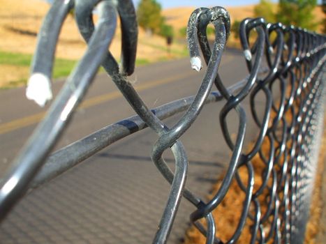 Close up of a chain link fence showing unique pattern.