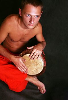 Man playing the nigerian drum in studio