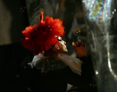 The image of the actor on a stage with soap bubbles