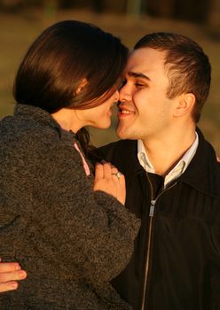 Happy young couple in nature on a sunset