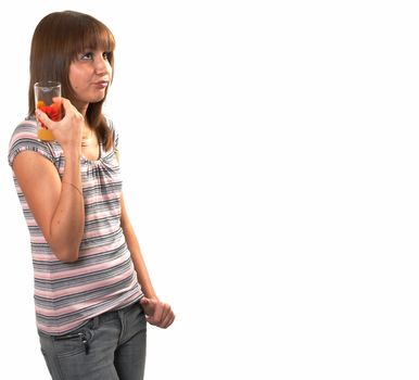 The girl drinking juice on a white background 