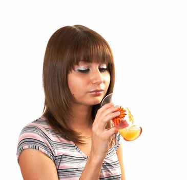 The girl drinking juice on a white background 