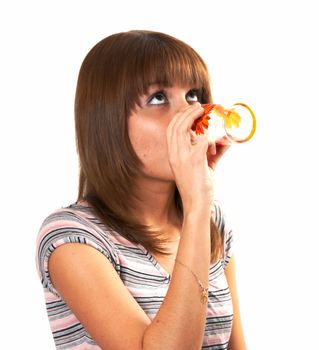 The girl drinking juice on a white background 