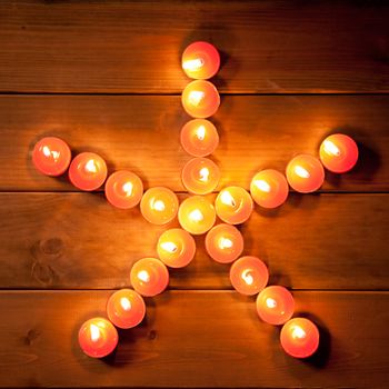 christmas candles pentagram star on golden warm wood