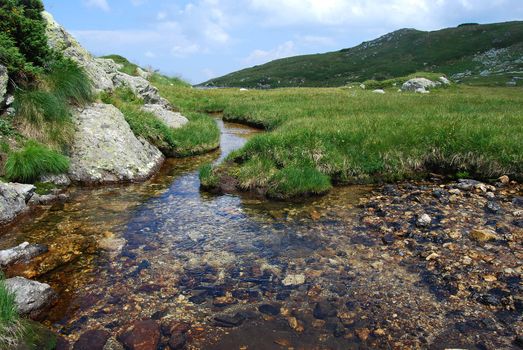 Clear high mountain spring waters in summer