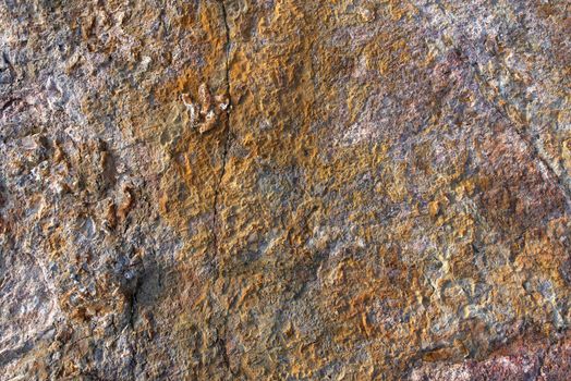 Surface of the rock with yellow, gold and brown tint for background
