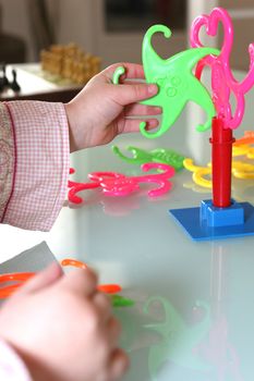 Toddler playing with plastic game