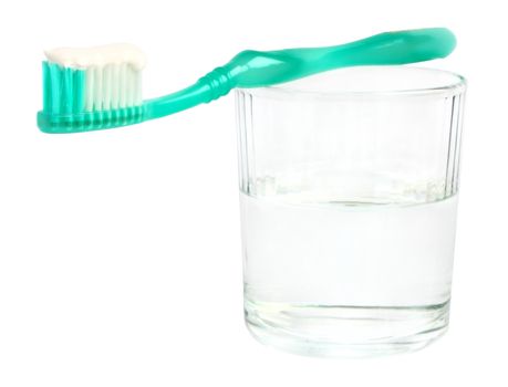 Glass and toothbrush on a white background.