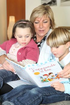 Mother and two children reading together