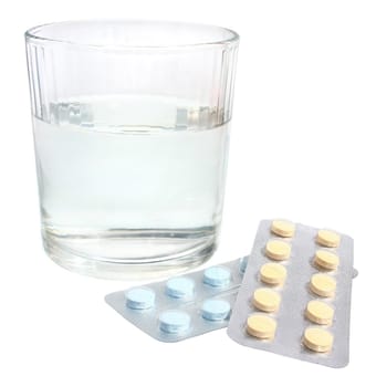 Glass and pills on a white background.