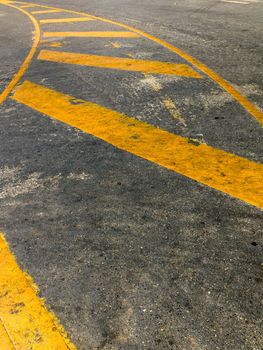 Perspective Yellow curve line paint on road ground