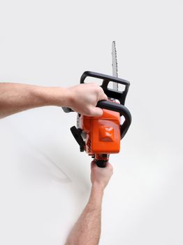 man hands holding a chainsaw