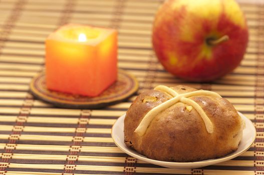 Cross bun with raisins and dried apricots, romantic still life