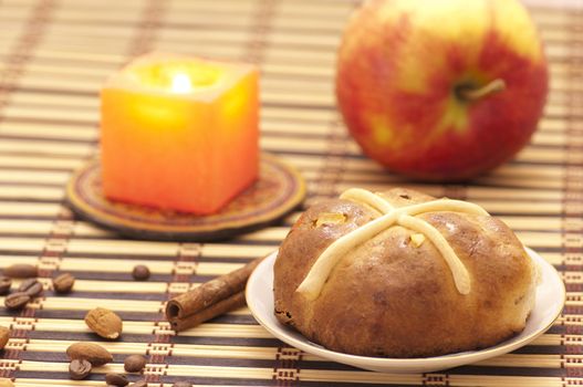 Cross bun with raisins and dried apricots, romantic still life