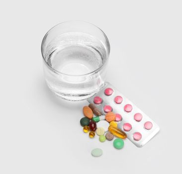 glass of water and vitamins, pills and tablets