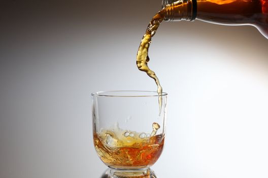 whiskey being poured into a glass