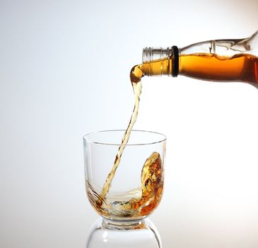 whiskey being poured into a glass