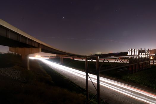 traffic light trails under bridge