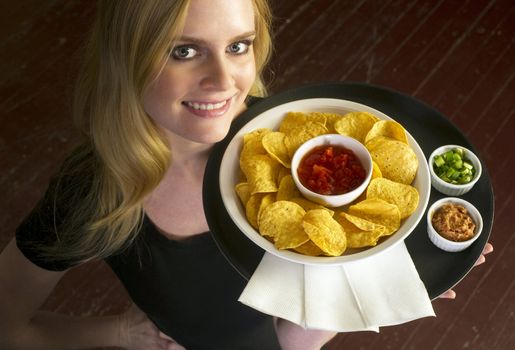 A Young Attractive Female Server Brings Appetizer Food Tray