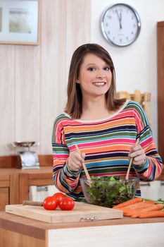 young woman making salad