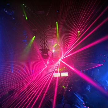 Colored laser party in entertainment disco club