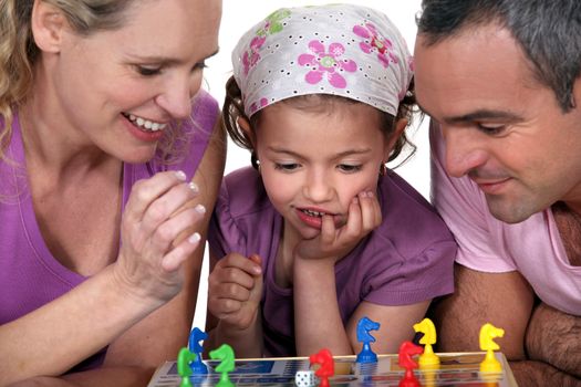 Young family playing a board game