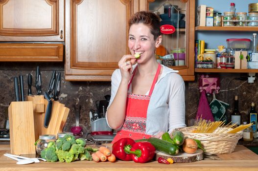 beautiful housewife cooking vegetables in the kitchen