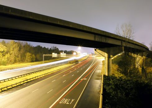 traffic light trails under bridge