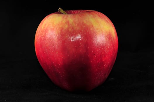 fresh red apple on black background