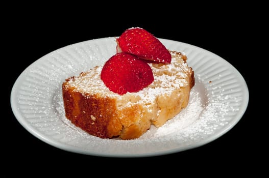 pound cake with strawberry on black