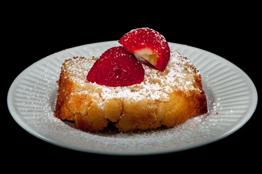 pound cake with strawberry on black